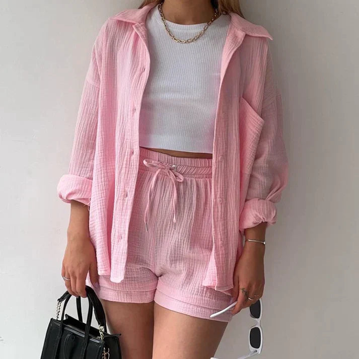 Soft light pink relaxed two-piece set with shirt and shorts for women, providing a gentle, comfortable, and stylish vibe.