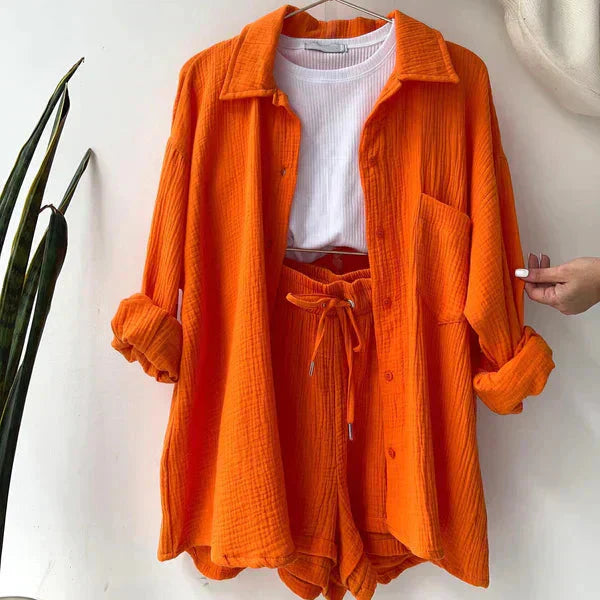 Vibrant orange relaxed two-piece set with a shirt and shorts, designed for a comfortable and stylish look for women.