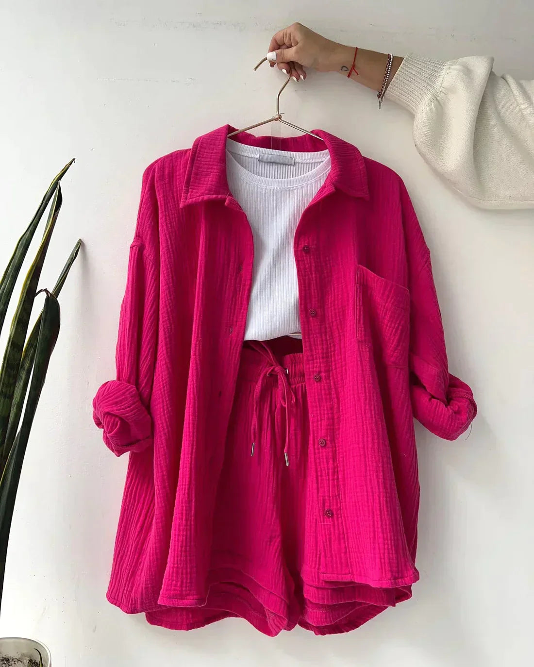 Bold red pink relaxed two-piece set with shirt and shorts, offering a fun and energetic style for women.