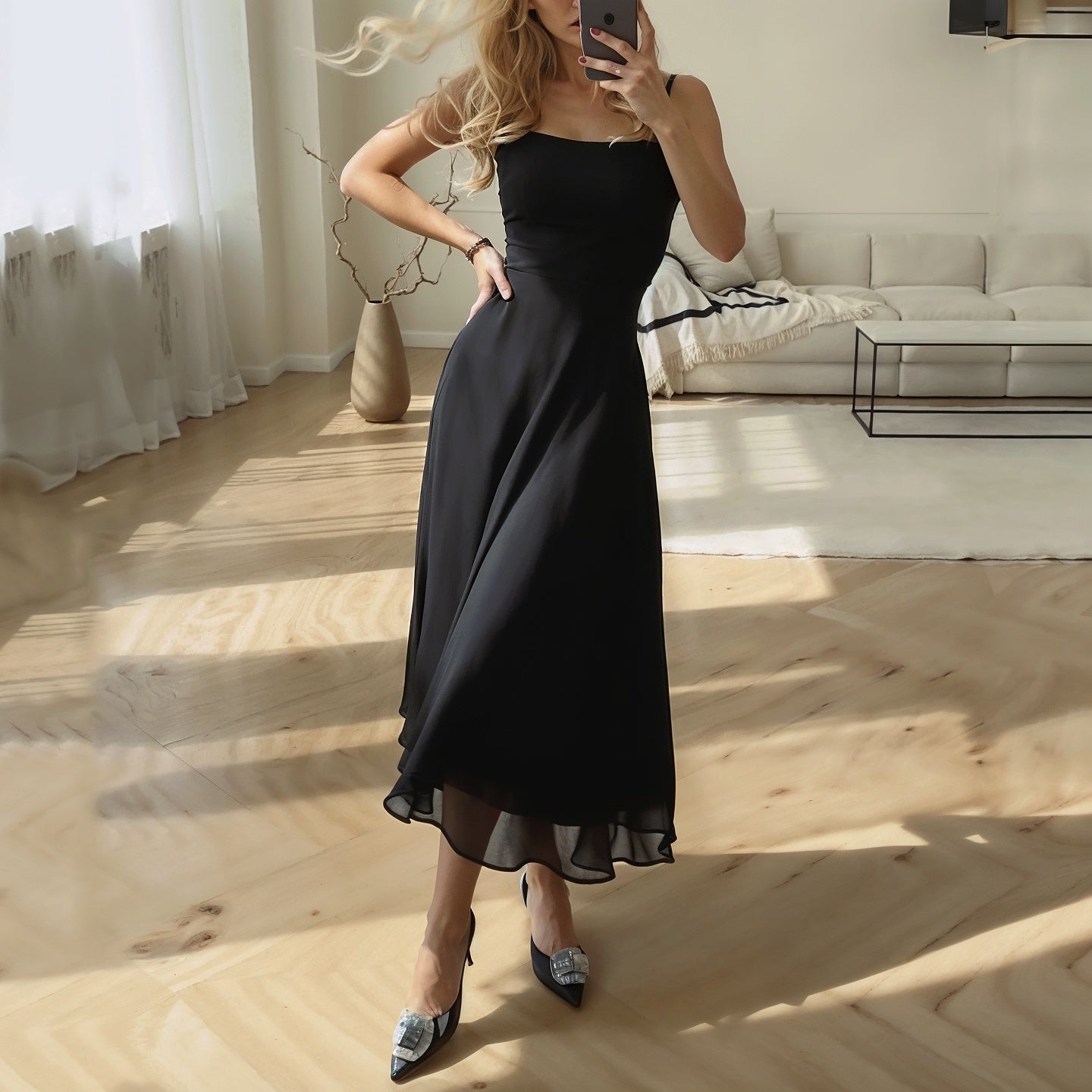 Classic midi dress in black with square neckline and flowy skirt, offering a sophisticated look for women. A versatile women's dress.