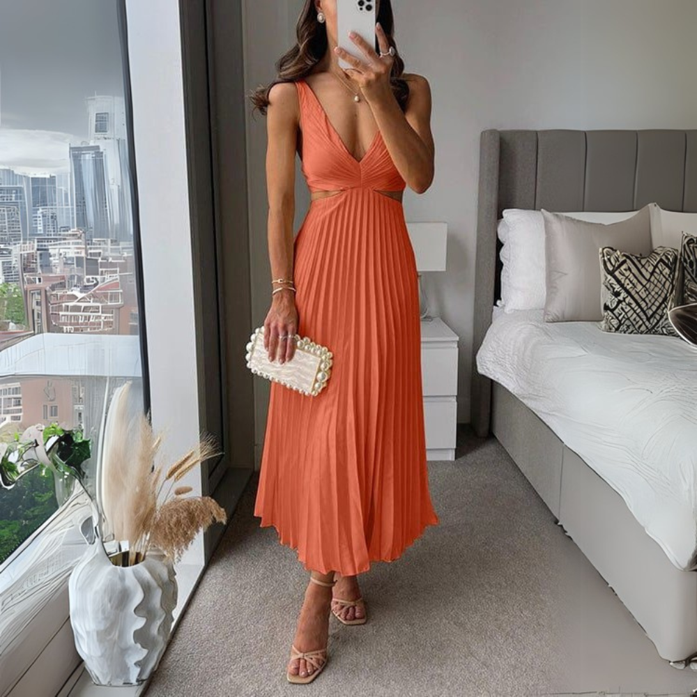 Stylish pleated midi dress in orange with trendy cutout design for women. A lively and warm women's dress, perfect for summer events.