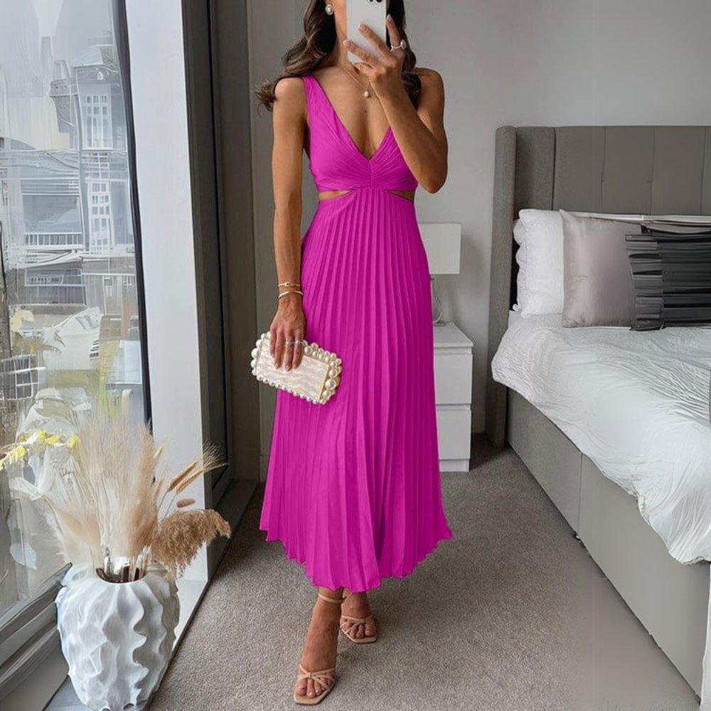 Stylish pleated midi dress in pink with trendy cutout design for women. A playful and feminine women's dress for various occasions.