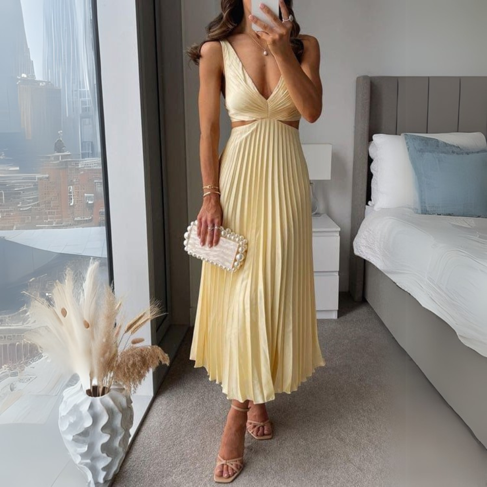Stylish pleated midi dress in yellow with trendy cutout design for women. A bright and cheerful women's dress that stands out.