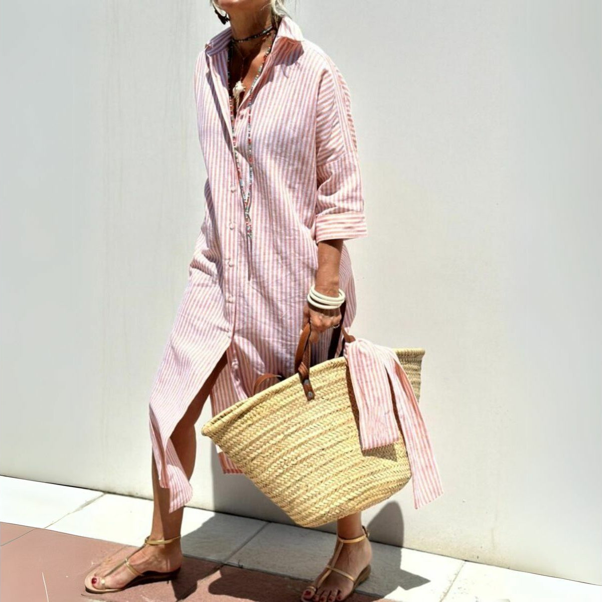 Pink striped oversized beach shirt dress for women, featuring a button-down design and perfect for beach outings.